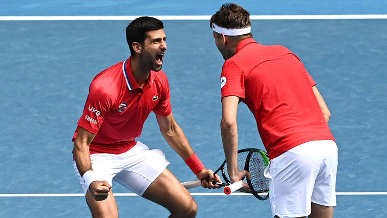 Novak Djokovic and Filip Krajinovic celebrate their success against Canada