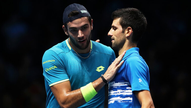 Matteo Berrettini (left) after his defeat by Novak Djokovic (right)