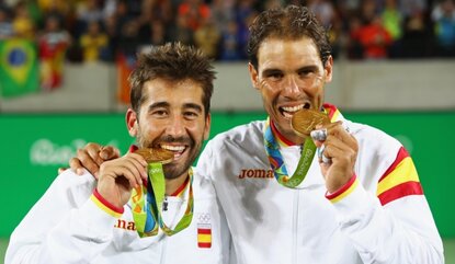 RIO DE JANEIRO, BRAZIL - AUGUST 12: (L-R) Gold medalists Rafael Nadal and Marc Lopez of Spain celebrate on the podium after the Men's Doubles competition on Day 7 of the Rio 2016 Olympic Games at the Olympic Tennis Centre on August 12, 2016 in Rio d...