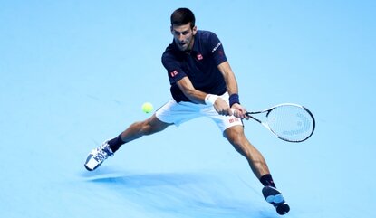 LONDON, ENGLAND - NOVEMBER 13: Novak Djokovic of Serbia hits a backhand during his men's singles match against Dominic Thiem of Austria on day one of the ATP World Tour Finals at O2 Arena on November 13, 2016 in London, England. (Photo by Julian Fi...