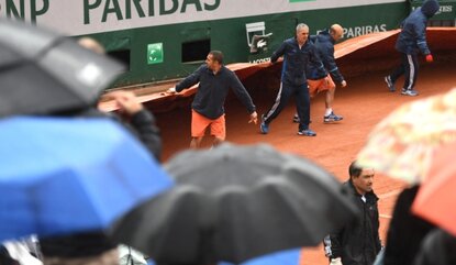 PARIS, FRANCE - MAY 22: Ground staff pull on the covers as rain causes play to be abandoned for the day on day one of the 2016 French Open at Roland Garros on May 22, 2016 in Paris, France. (Photo by Dennis Grombkowski/Getty Images)