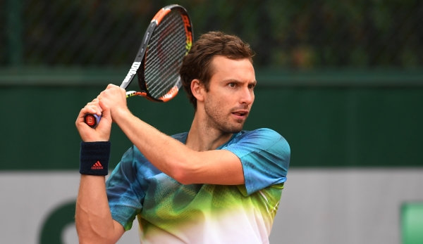 PARIS, FRANCE - MAY 24: Ernests Gulbis of Latvia plays a backhand during the Men's Singles first round match against Andreas Seppi of Italy on day three of the 2016 French Open at Roland Garros on May 24, 2016 in Paris, France. (Photo by Dennis Gro...