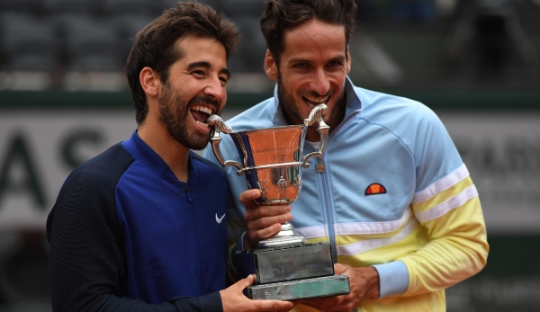 PARIS, FRANCE - JUNE 04: Marc Lopez and Feliciano Lopez of Spain celebrate with the trophy following their victory during the Men's Doubles final match against Mike Bryan and Bob Bryan of the United States on day fourteen of the 2016 French Open at ...