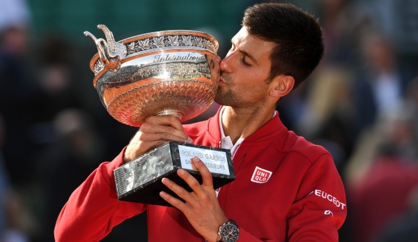 PARIS, FRANCE - JUNE 05: Champion Novak Djokovic of Serbia kisses the trophy following his victory during the Men's Singles final match against Andy Murray of Great Britain on day fifteen of the 2016 French Open at Roland Garros on June 5, 2016 in P...