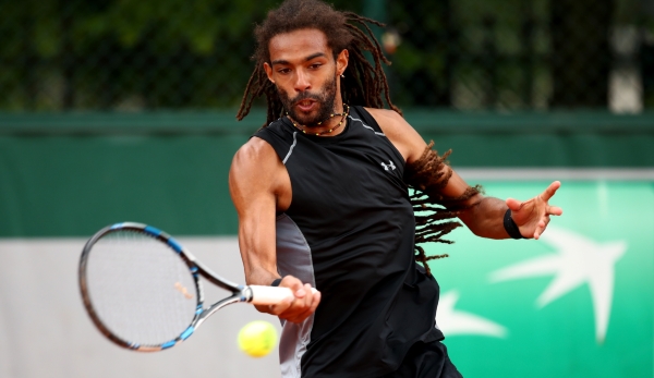 PARIS, FRANCE - MAY 22: Dustin Brown of Germany hits a forehand during the Men's Singles first round match against Dudi Sela of Israel on day one of the 2016 French Open at Roland Garros on May 22, 2016 in Paris, France. (Photo by Clive Brunskill/G...