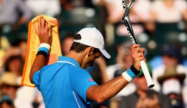 KEY BISCAYNE, FL - MARCH 31: Novak Djokovic of Serbia holds up his racket after smashing it against Alexandr Dolgopolov of the Ukraine in their fourth round match during the Miami Open Presented by Itau at Crandon Park Tennis Center on March 31, 201...