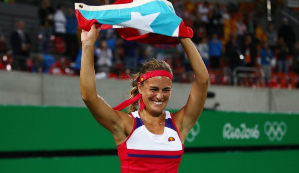 RIO DE JANEIRO, BRAZIL - AUGUST 13: Monica Puig of Puerto Rico reacts after defeating Angelique Kerber of Germany in the Women's Singles Gold Medal Match on Day 8 of the Rio 2016 Olympic Games at the Olympic Tennis Centre on August 13, 2016 in Rio d...