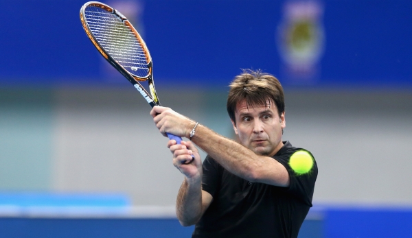 DUBAI, UNITED ARAB EMIRATES - DECEMBER 11: Fabrice Santoro of the Indian Aces in action against Patrick Rafter of the Singapore Slammers during the Coca-Cola International Premier Tennis League fourth leg at the Hamdan Sports Complex, December 11, 2...